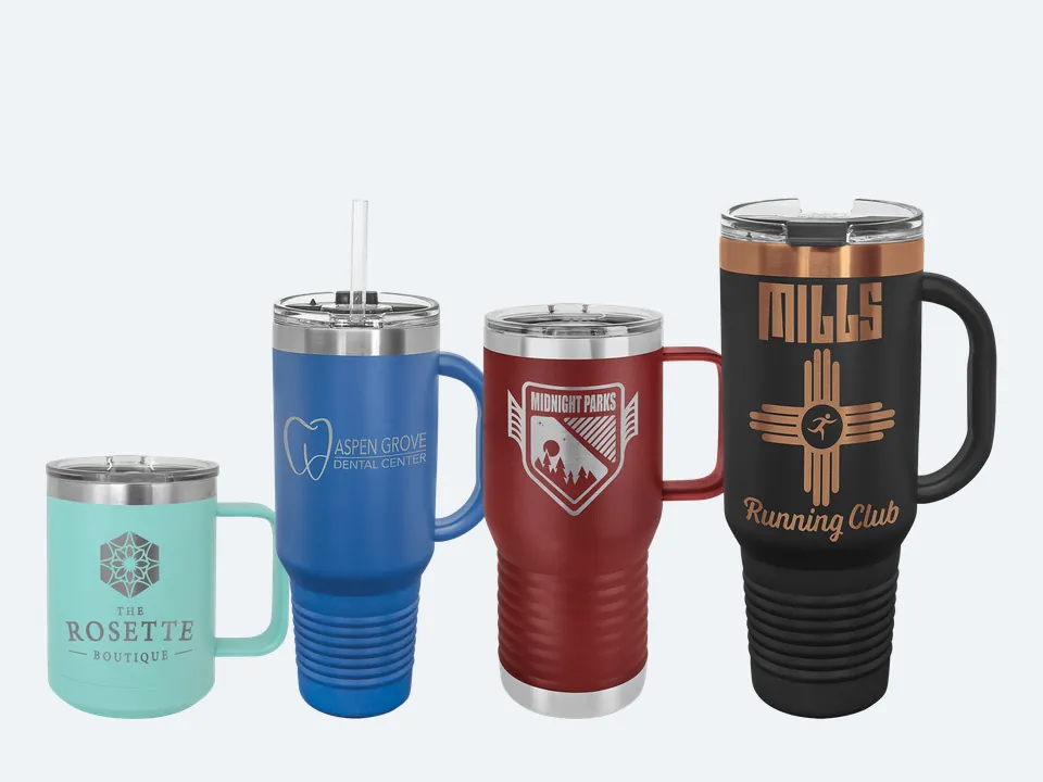 Four Polar Camel mugs with sample engravings: a teal 15 oz coffee mug, a royal blue 40 oz travel mug with a straw, a maroon 20 oz travel mug and a black and rose gold 40 oz travel mug