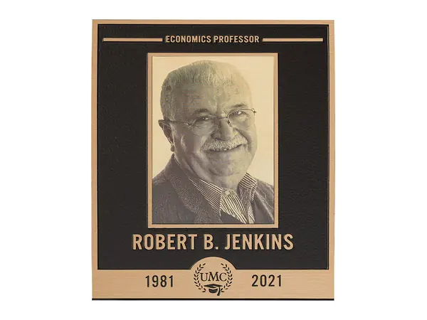 An example of a bronze plaque with an etched photo portrait above the name and years