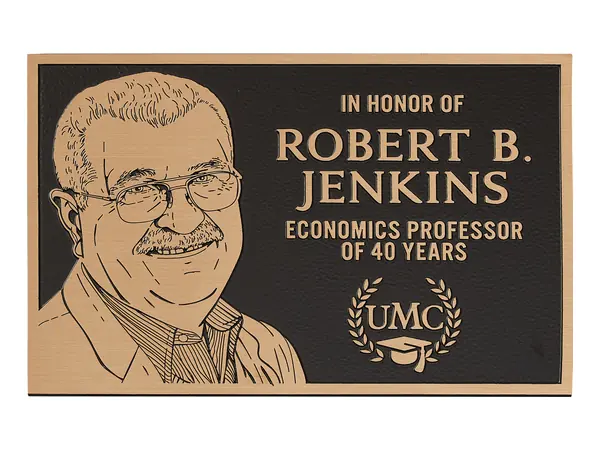 An example of a bronze plaque with a flat relief portrait of a smiling man beside raised lettering