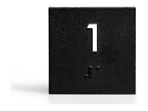 An example of a black ADA room number sign with a raised number 1 and braille