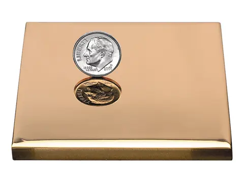 A polished bronze sample plate with a mirror shine, with a dime on it for scale