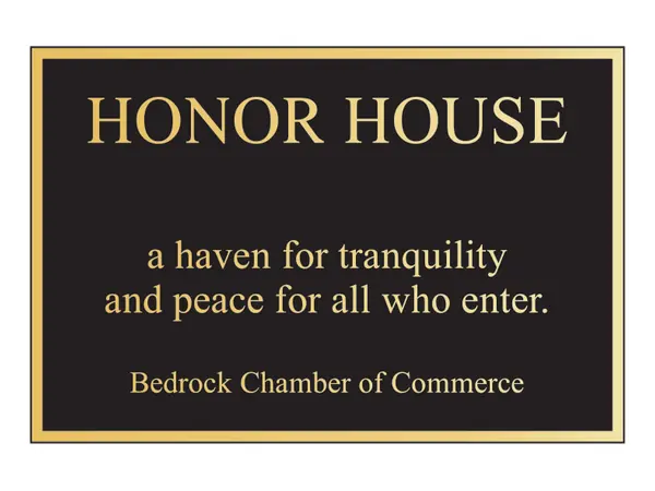 An example of a traditional cast bronze plaque reading Honor House, a haven for tranquility and peace for all who enter